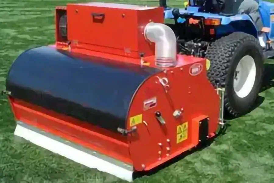 A turf vacuum attached to a small tractor.
