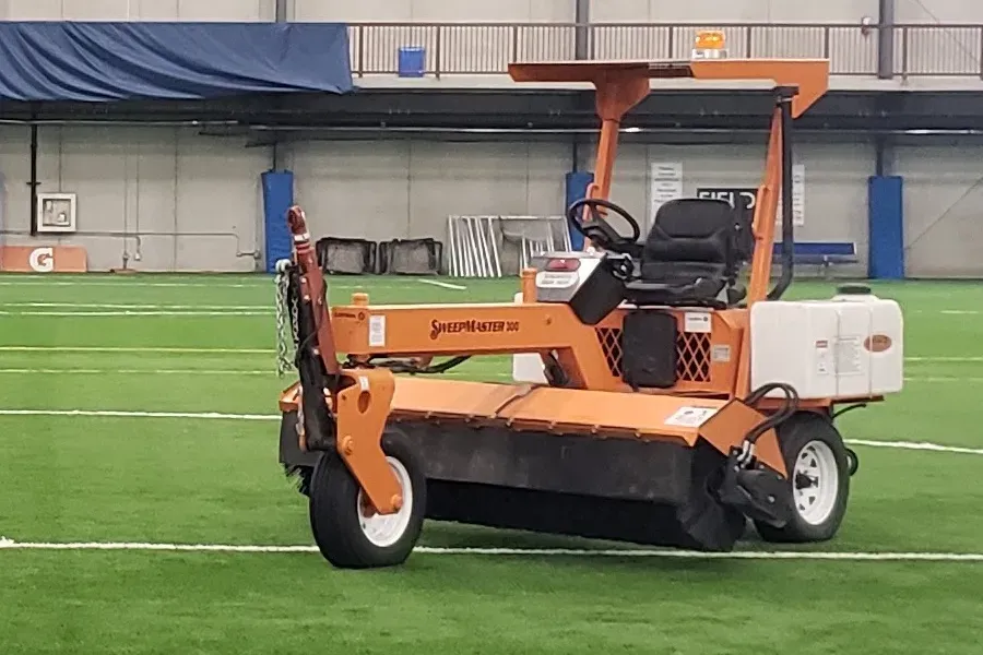 A rideable turf maintenance machine.