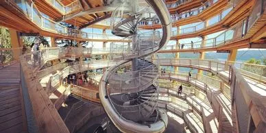 A multi-story indoor play structure featuring spiral staircases and walkways.