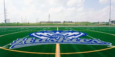 A sports field featuring a Huskies team logo.