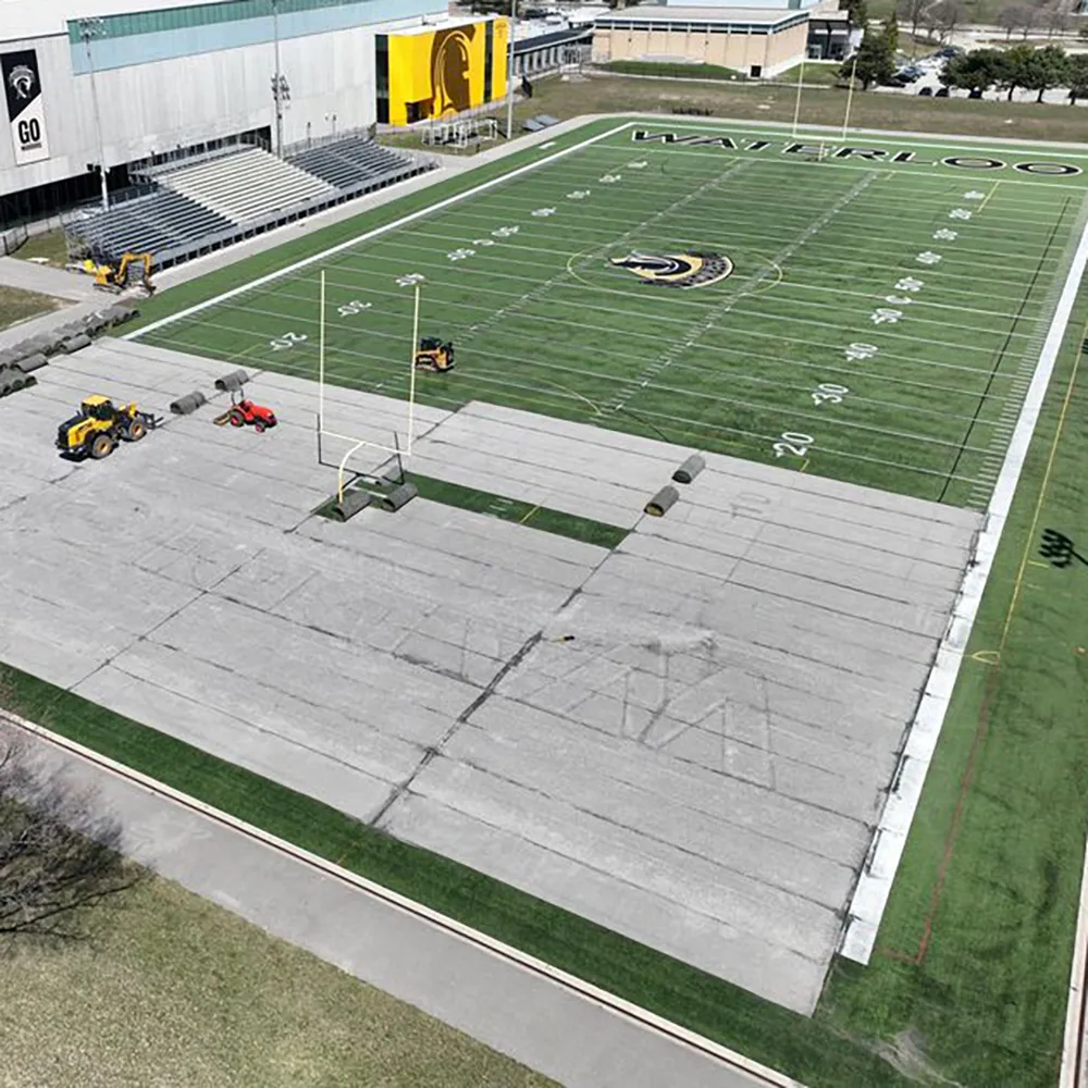 A 39 Seven construction crew replaces the artificial turf on the University of Waterloo football field.